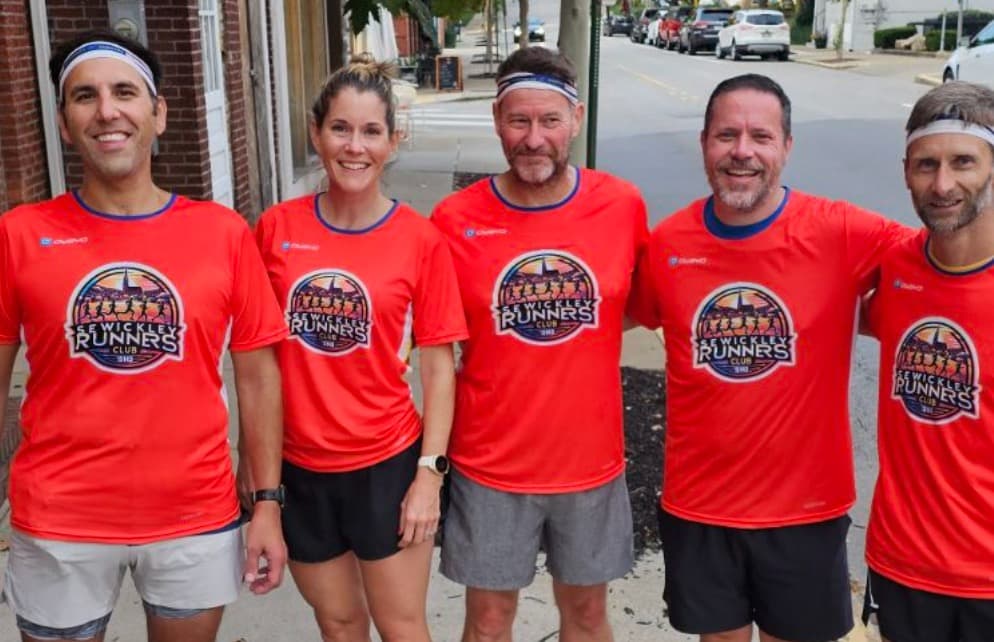 Five Sewickley Run Club members wearing SRC jerseys on Beaver Avenue